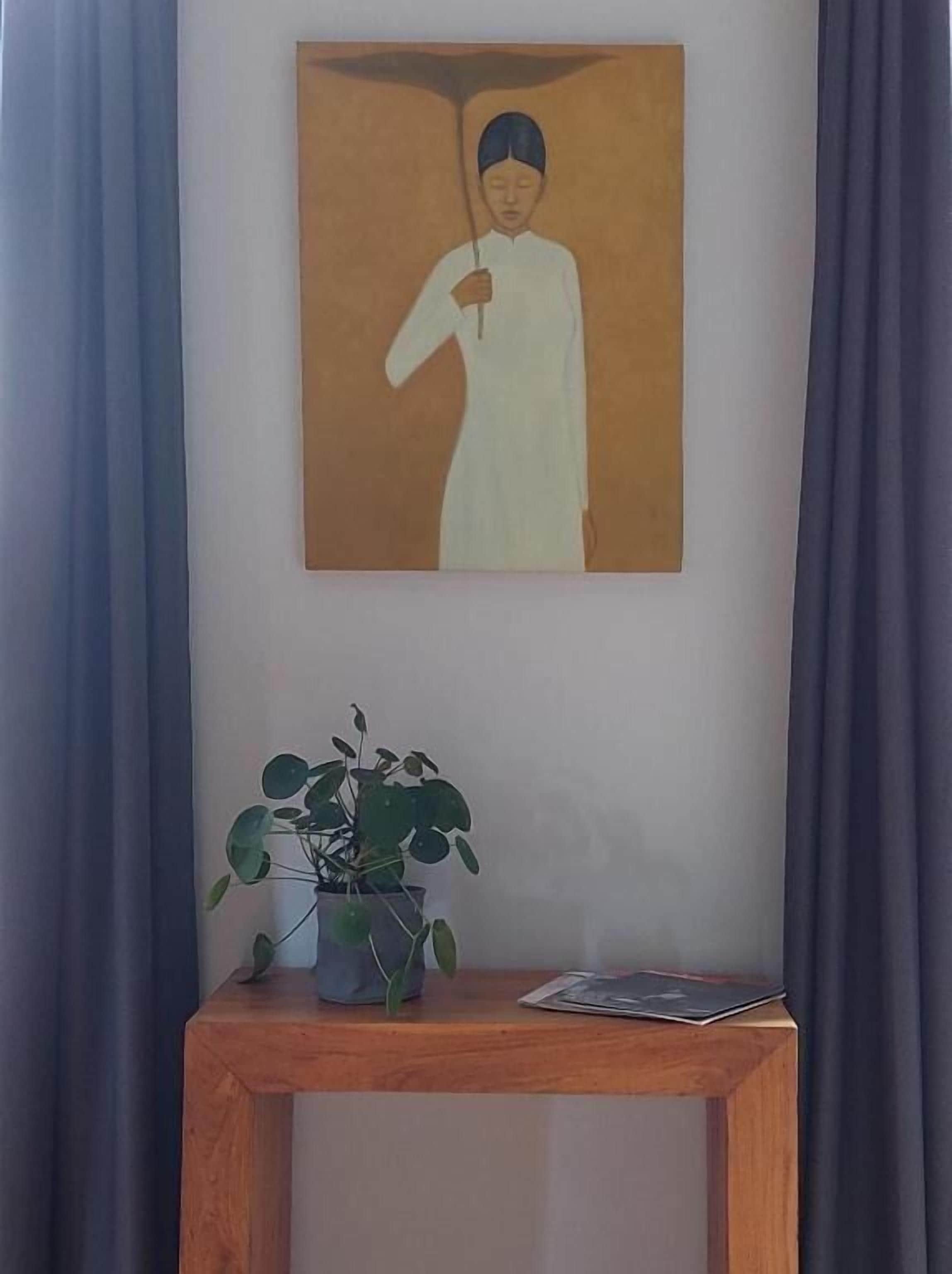 A painting of a figure holding an umbrella, a potted plant, and a magazine on a wooden table against a wall.