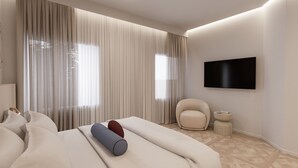 Une chambre d’hôtel moderne dotée d’un grand lit, d’un téléviseur à écran plat, d’un fauteuil confortable et d’une petite table d’appoint.