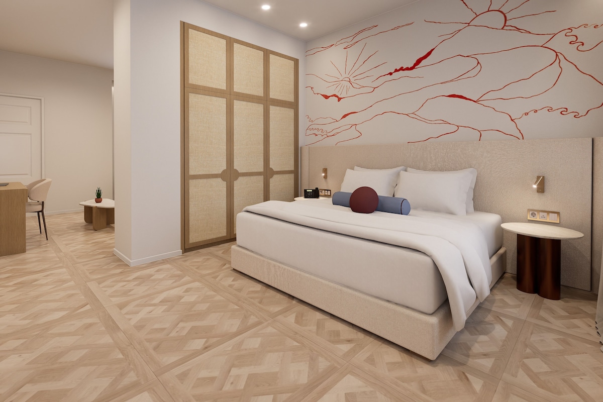 Ein modernes Schlafzimmer mit einem großen Bett, einem Schreibtisch und einem Stuhl.