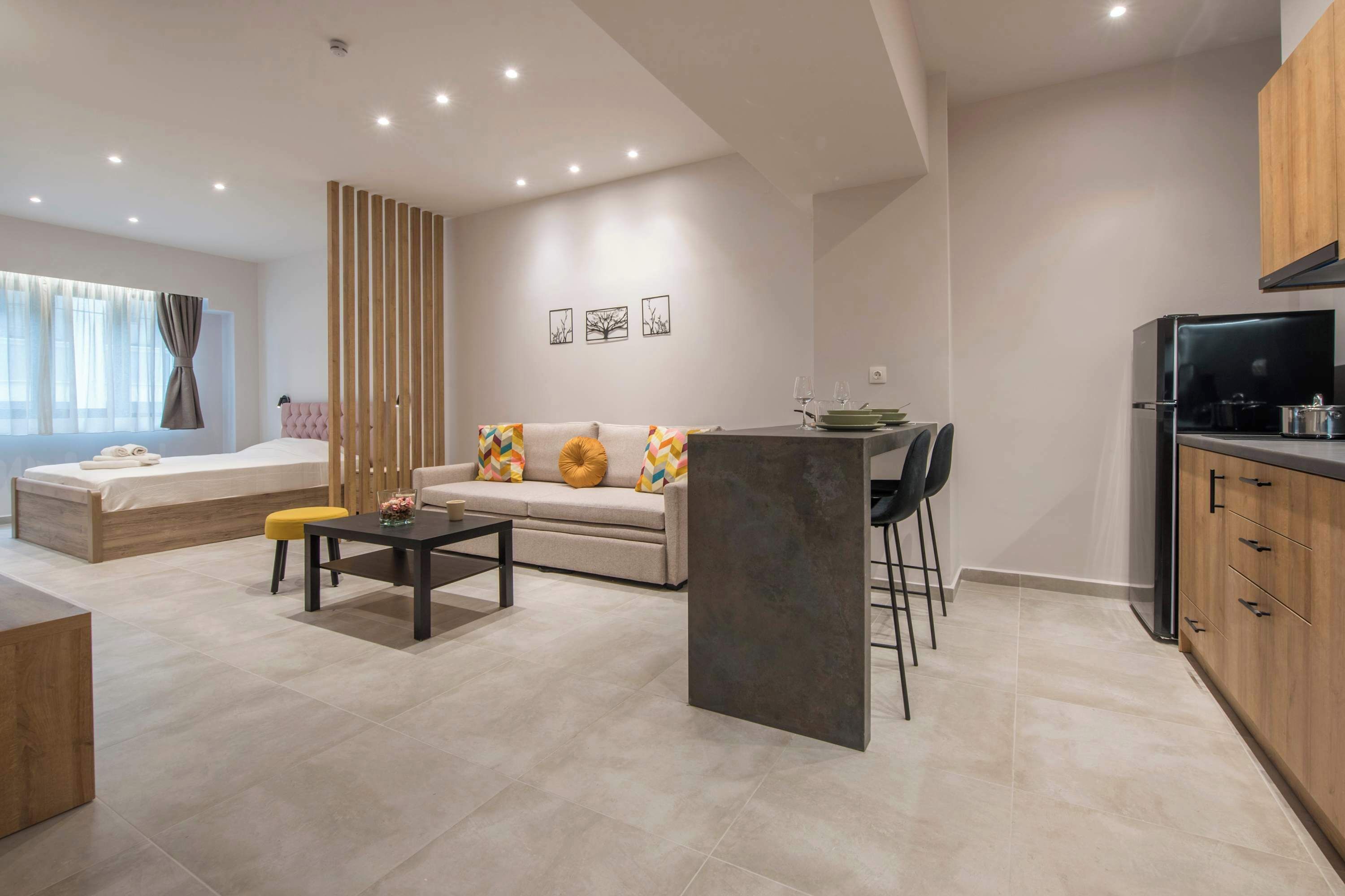 A modern living room with a sofa, coffee table, and a dining area with chairs.