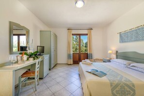 A bedroom with a bed, a desk, a chair, a wardrobe, and a window with curtains. - HOTEL BIDERROSA (Orosei)