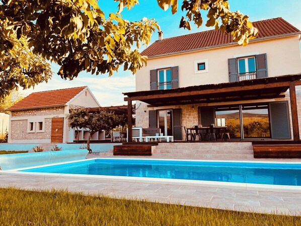 A two-story house with a swimming pool, stone walls, and a covered patio area. - *NEW* Exclusive, charming country home in Dalmatia. Perfect for friends and family! (Umljanovići)