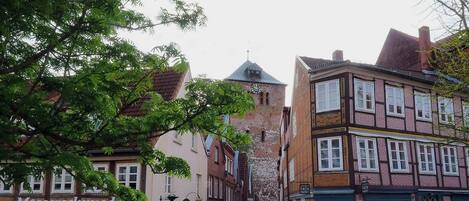 A historic building with a clock tower, traditional European architecture, and a sign for 'Stader Fach Markt'.