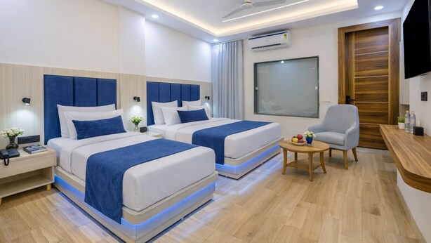A modern hotel room with two beds, a desk, a chair, and a TV. - Hotel Air Admire - IGI Airport Delhi (New Delhi)