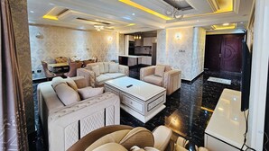 A modern living room with a sofa set, a coffee table, and a dining table.