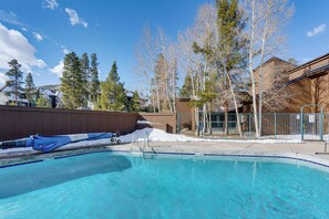 A clear swimming pool with a blue border, surrounded by trees and buildings. - 3 Mi to Keystone Resort: Updated Condo w/ Balcony! (Keystone)