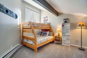 A bunk bed with a headboard, a small bedside table, a lamp, and a bookshelf. - 3 Mi to Keystone Resort: Updated Condo w/ Balcony! (Keystone)