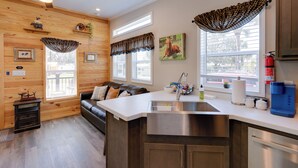 A modern kitchen with a central island, stainless steel appliances, and a built-in dishwasher. - Rodeo Thrills & Backyard Bbqs! Lake Wales Retreat (River Ranch)