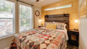A bedroom with a large bed, a ceiling fan, a wooden headboard, and a window with blinds. - Rodeo Thrills & Backyard Bbqs! Lake Wales Retreat (River Ranch)