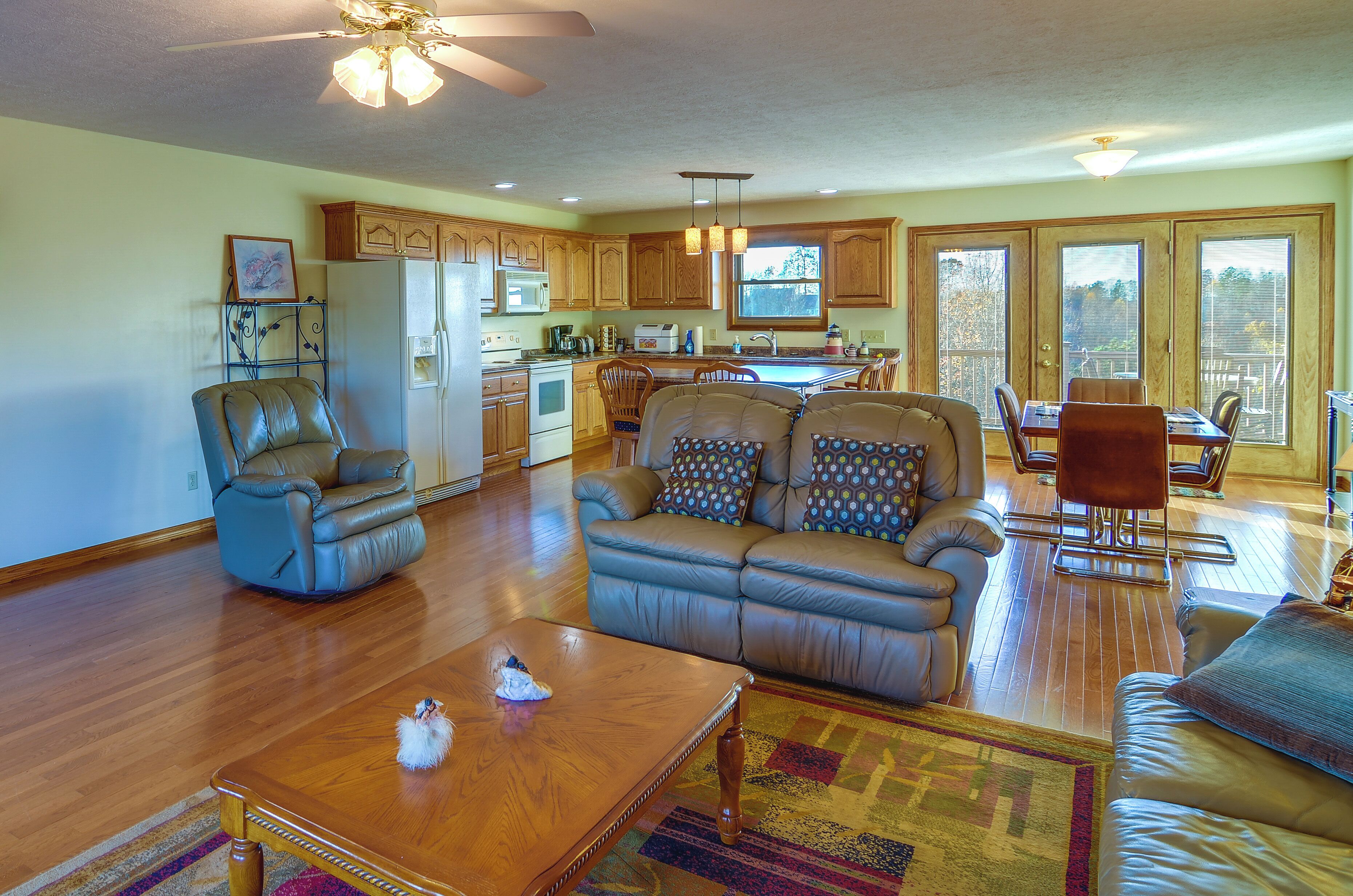 A spacious living room with a sofa, a coffee table, and a dining area with a table and chairs.
