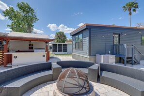 A patio area with outdoor seating, a pergola, and a modern building structure.