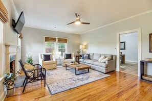 A living room with a fireplace, a ceiling fan, a sofa, a coffee table, and a rug. - 9 Mi to Georgia Southern University: Family Escape (Brooklet)
