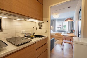 A modern kitchen with a built-in stove, a sink, and a knife rack. - Boutique-Apartment im Zentrum (Oberstdorf)