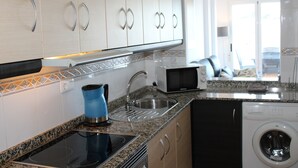 A modern kitchen with a built-in stove, sink, and dishwasher. - 2 Bedroom Apartment (MOJACAR)