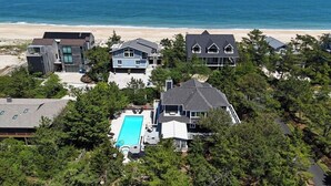 A coastal residential area with houses, a swimming pool, and a beach view. - 29532 N. Cotton Way - Cotton Patch East (Bethany Beach)