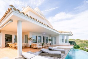 A modern house with a pool, outdoor seating, and a view of the landscape. - Casa Barbara - Harbor view (Es Castell)