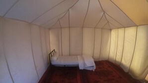 A tent with a bed, a mattress, and a headboard. - starlitdesertcamp (Foum Zguid)