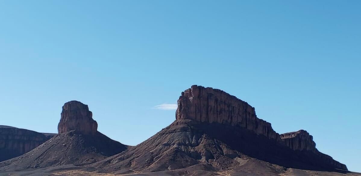 A desert landscape with prominent rock formations.