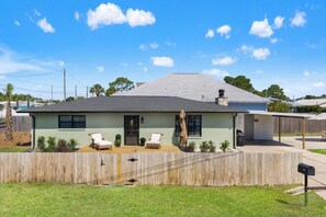 A single-story house with a covered patio, a fenced yard, and a mailbox. - Beach House - Blueberry Beach (Panama City Beach)