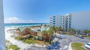 Un hôtel situé en bord de mer, doté de cabanes de plage, d’un parking et offrant une vue sur l’océan.