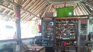 A small convenience store with a counter, shelves stocked with various products, and a refrigerator. - Punda Milia Paradise Hotel Shanzu (Mombasa)