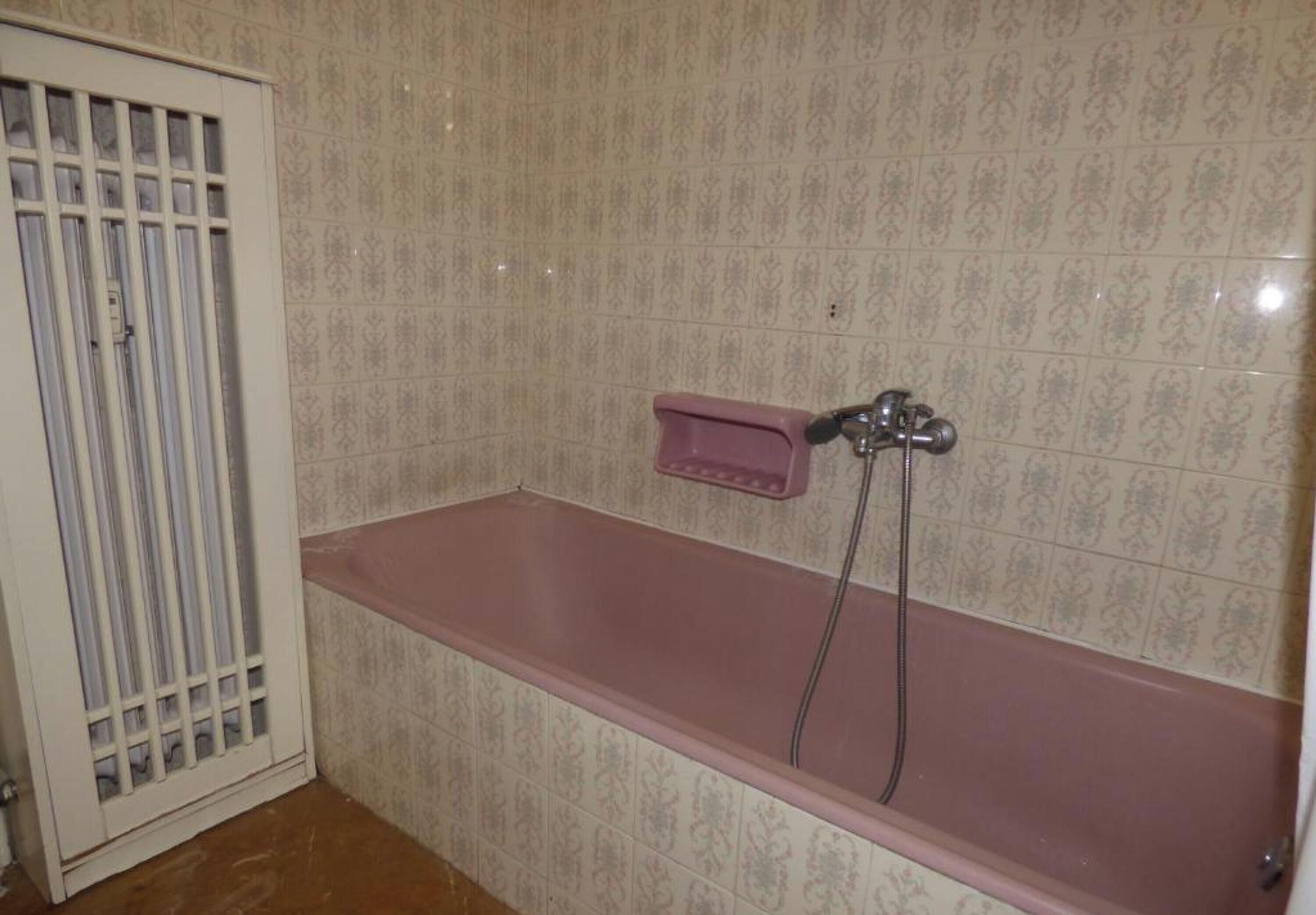 A bathroom with a bathtub, a shower, and a toilet.