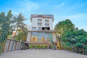 A modern building with a sign reading 'Collection.' - Classic With Balcony I- Siri Lodge (Pune)