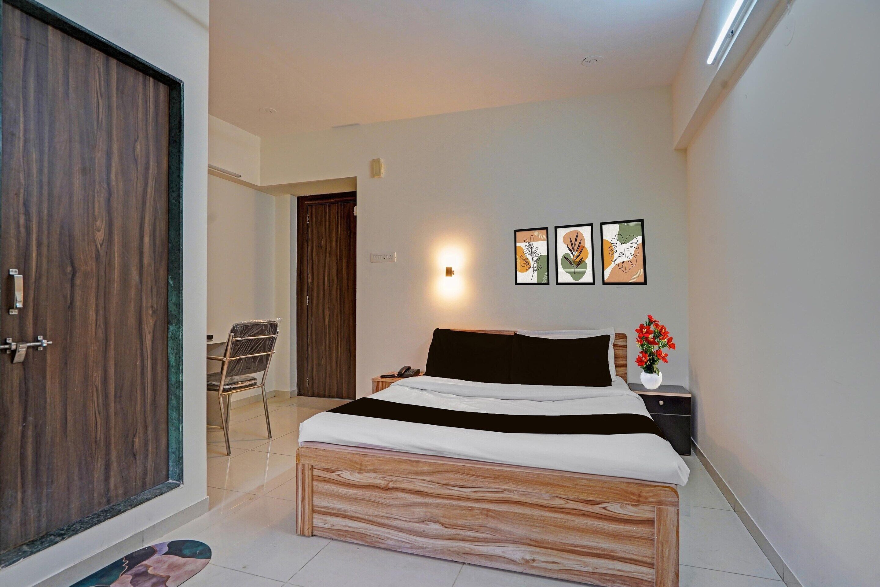 Un dormitorio con una cama de madera, una mesita de noche, una silla, un armario y una obra de arte colgada en la pared.