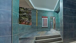 A staircase leading to a door with a sign indicating the Vihnawaru Complex. - Classic With Balcony I- Siri Lodge (Pune)