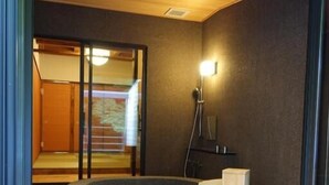 A modern bathroom with a built-in hot tub, a shower, and a glass door leading to a balcony. - YOKOKAWAONSEN YUDONO TOTONOYU (Shimoda)