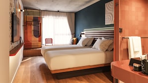 A modern hotel room with a large bed, a wooden floor, a bathroom with a mirror, and a view of the outdoors. - Hotel Schani Naschmarkt (Vienna)