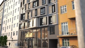 A multi-story building with a modern architectural design, featuring balconies and large windows. - Hotel Schani Naschmarkt (Vienna)