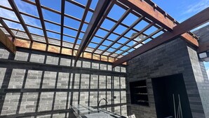 A construction site with exposed brick walls and a metal framework.