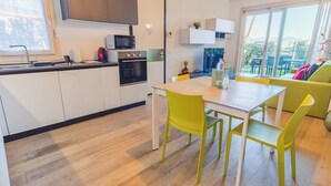 Una cocina moderna con comedor, sofá y vistas al exterior.