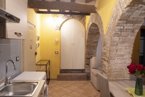 Interior - Cozy suite in the heart of Perugia, perfect for 2 guests.Elegant room, comfortable living room and kitchen equipped to feel right at home.The unique detail? The natural stone walls, which give charm and character to the environment.Bright and well-kept,  (Perugia)