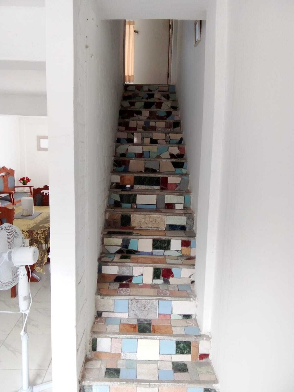 A staircase with a unique mosaic design.
