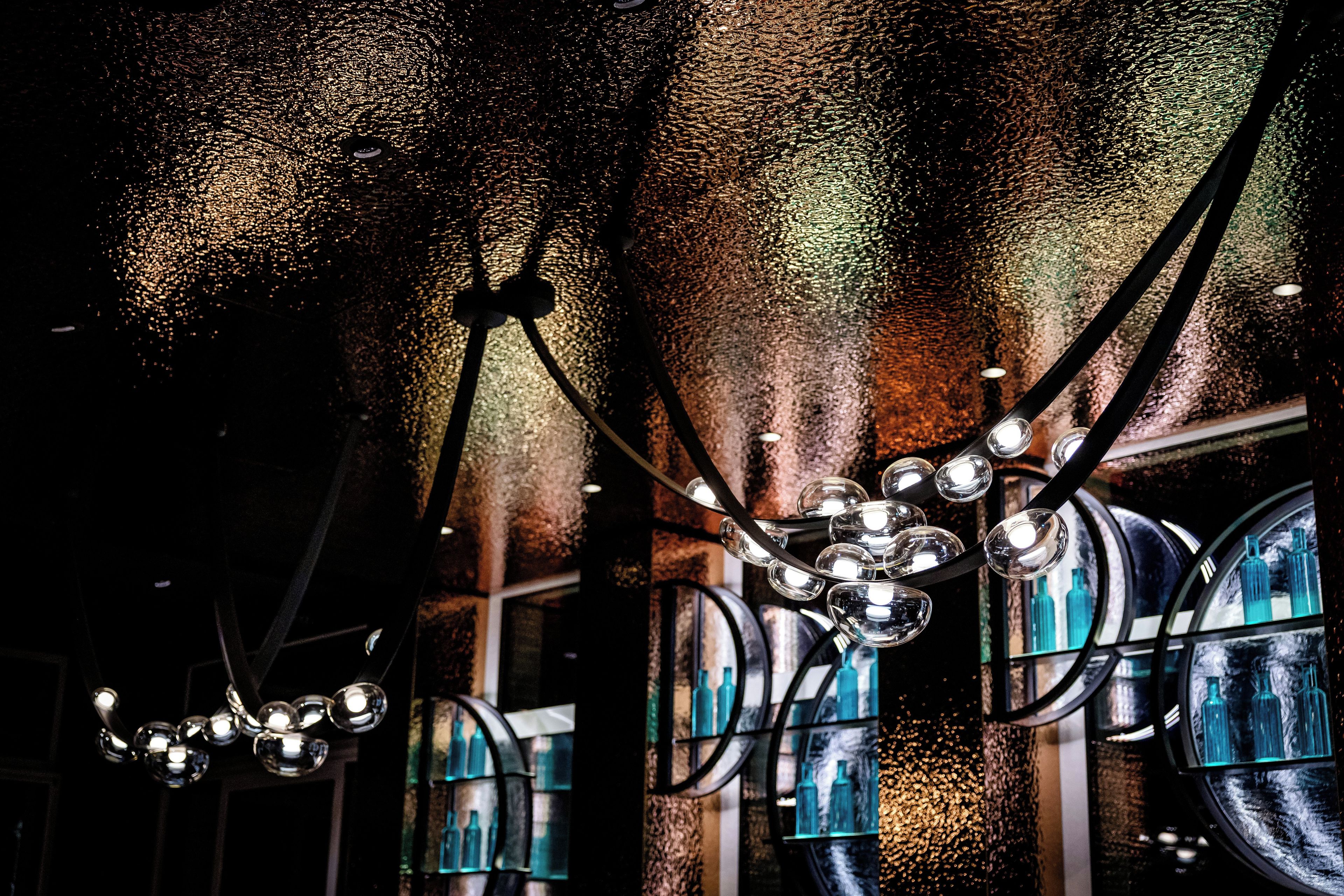 A chandelier with multiple spherical light fixtures suspended from the ceiling.