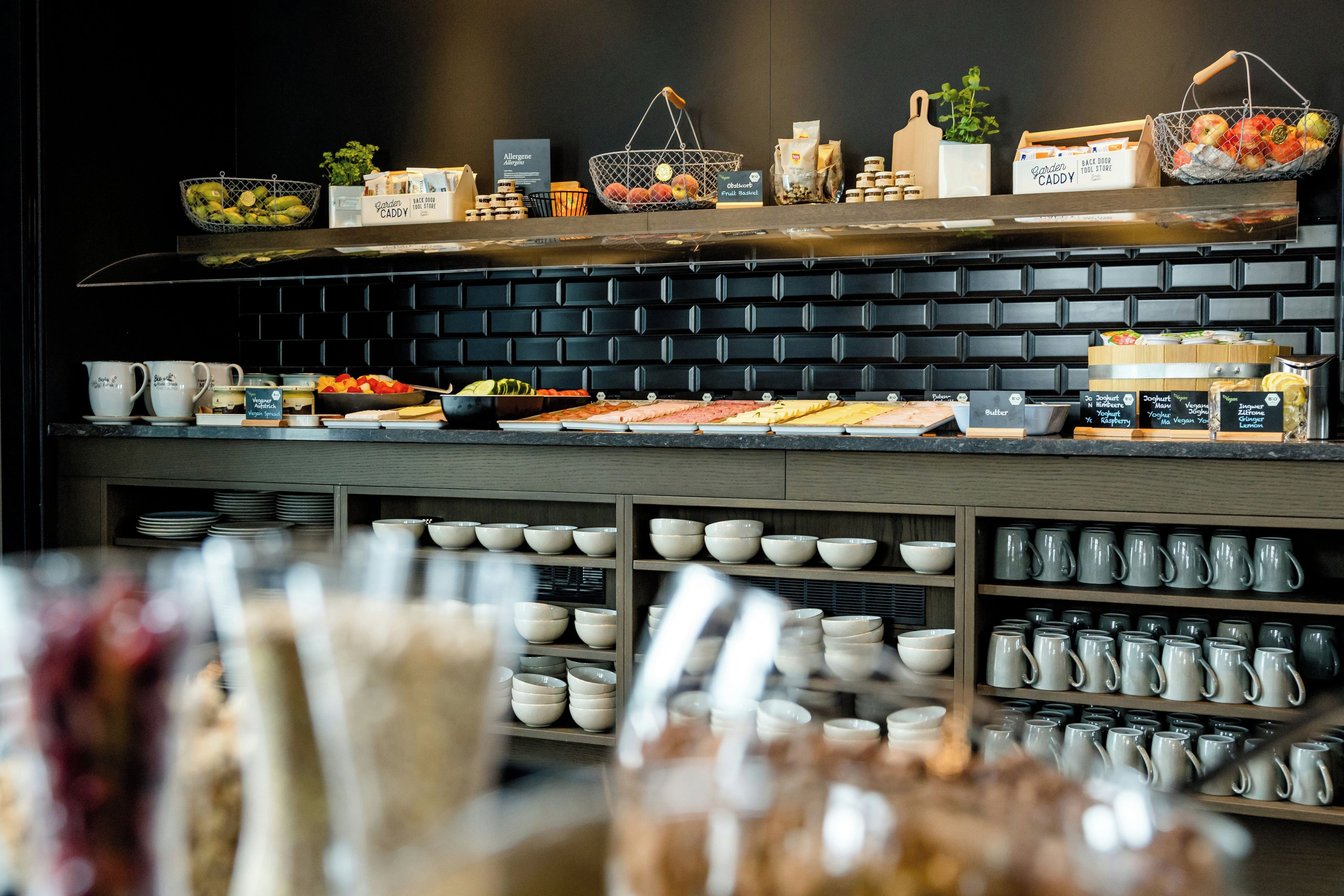 A buffet area with various food items and condiments.