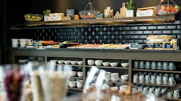 A buffet area with various food items and condiments.