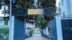 A gated entrance to a property named '7EVEN BOUTIQUE HOSTEL' with a clear pathway leading to the entrance. - 7even Boutique Hostel (Tirana)
