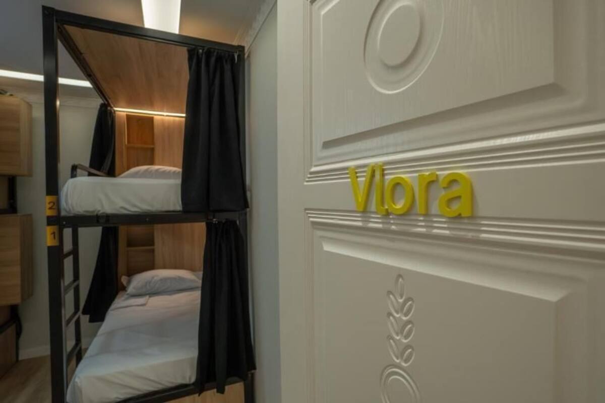 A bunk bed room with a white door labeled 'Viora' and a wooden wardrobe.