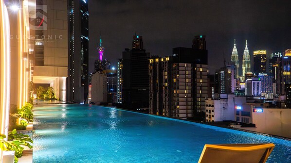 A rooftop pool with a city skyline in the background.