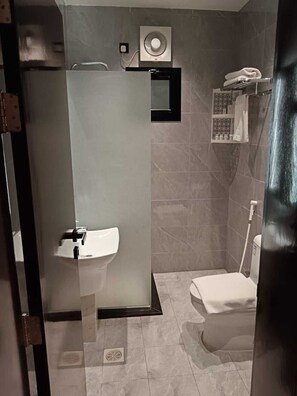 A modern bathroom with a glass partition, a sink, a toilet, and a towel rack. - Fursan Al Arab Serviced Apartments  (Jeddah)