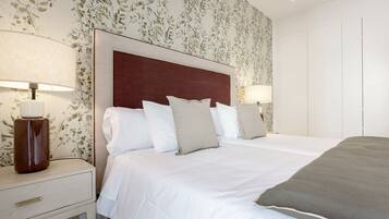 Una habitación de hotel con cama, mesitas de noche y lámparas.