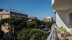 A hotel named 'HOTEL NAZIONALE' with a balcony, trees, and buildings in the background. - Cattel A05 with Private Terrace and Air Conditioning (Lido di Jesolo)