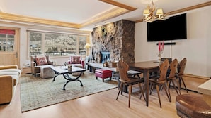 A spacious living area with a fireplace, dining table, and comfortable seating. - Lodge Tower 578 2BR at the base of Vail Mountain (Vail)