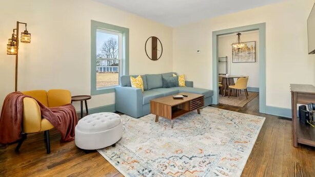 A living room with a sofa, ottoman, coffee table, and a patterned rug. - Steps to Ariel Park / Renovated 2BR Retreat (Mount Vernon)