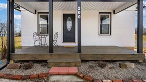 A two-story house with a porch, a black door, and the number 200 on the wall. - Steps to Ariel Park / Renovated 2BR Retreat (Mount Vernon)