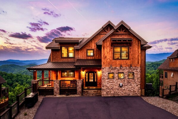 A large wooden house with a stone foundation, multiple windows, and a porch. - Pool/HotTub/GameRoom/Theater/FirePit/VIEWS - Coal Camp Lodge (Sevierville)