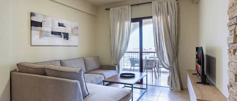 Apartment, Balcony, City View | Living area | 65-inch Smart TV with digital channels